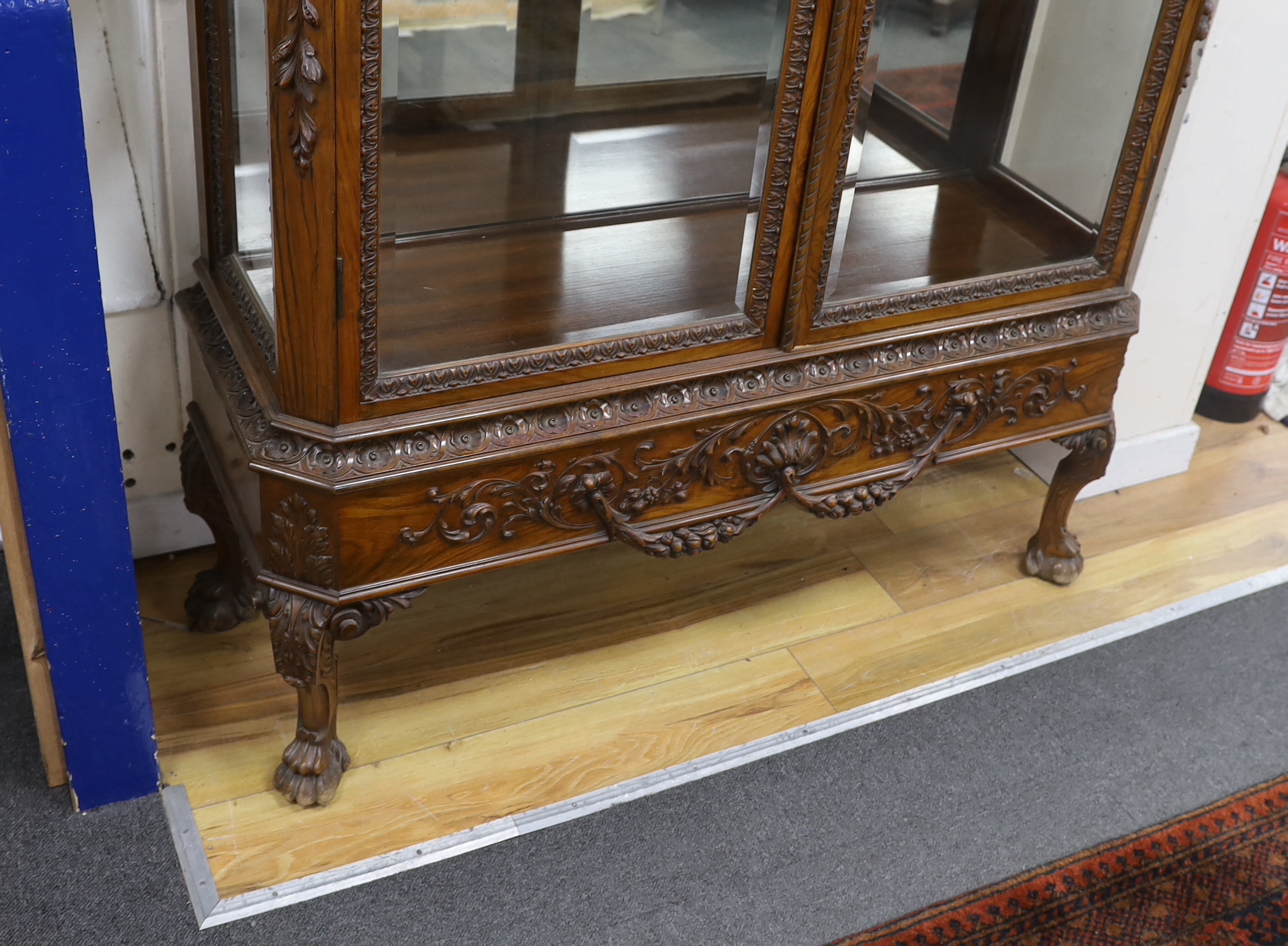 An early 20th century George I style carved walnut vitrine, width 138cm, depth 50cm, height 218cm
